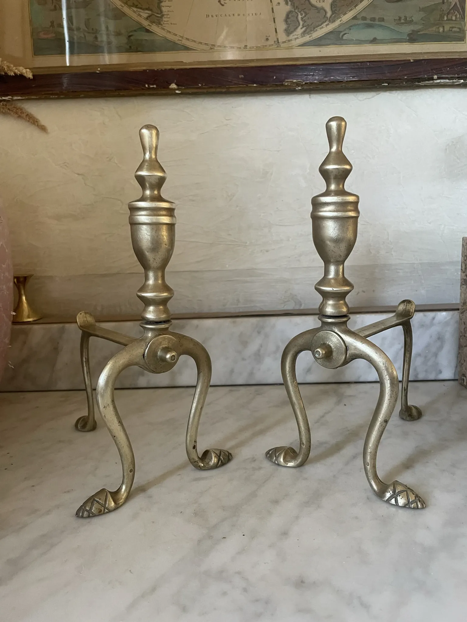 Pair of Victorian brass fire dogs from the late 19th century.
