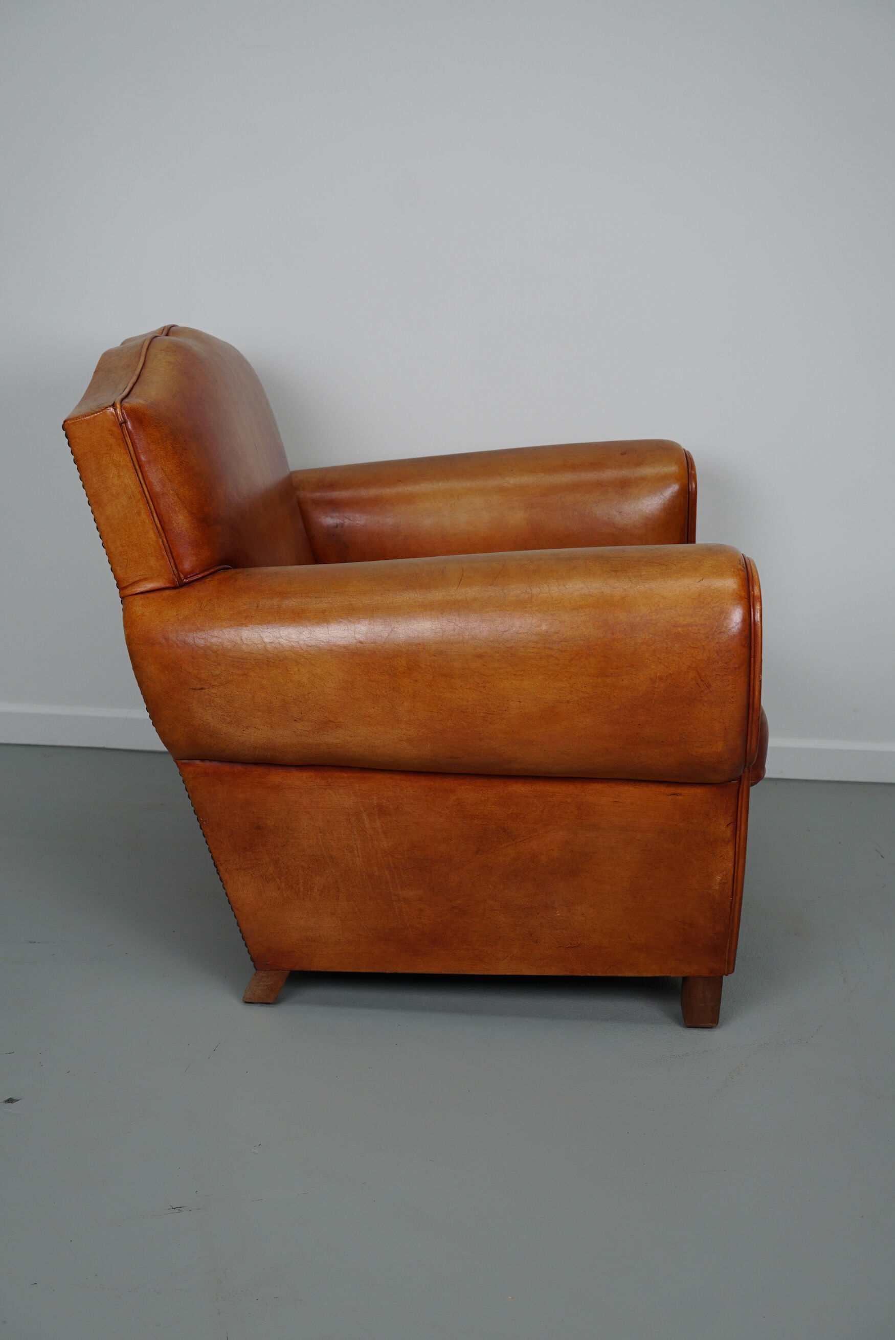 Vintage french moustache back cognac-colored leather club chair