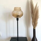 Table lamp with an antique textured globe and a golden base