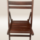Pair of folding chairs made of dark wood slats.