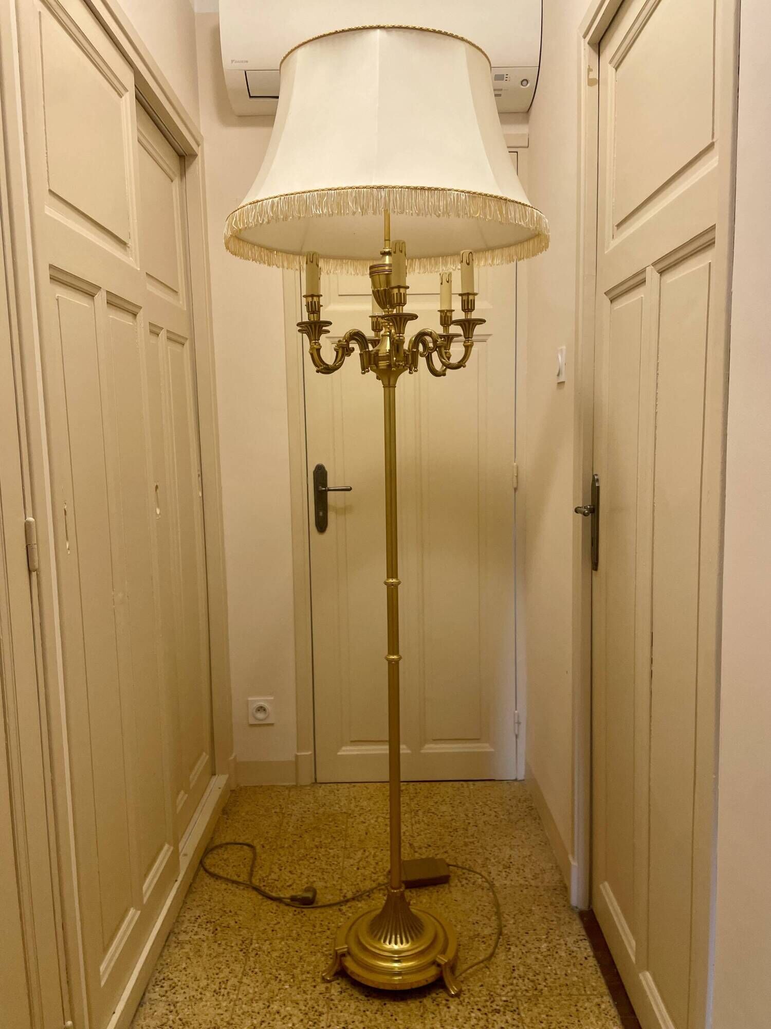 Bronze floor lamp by Lucien Gau, with a six-light shade model 16136.