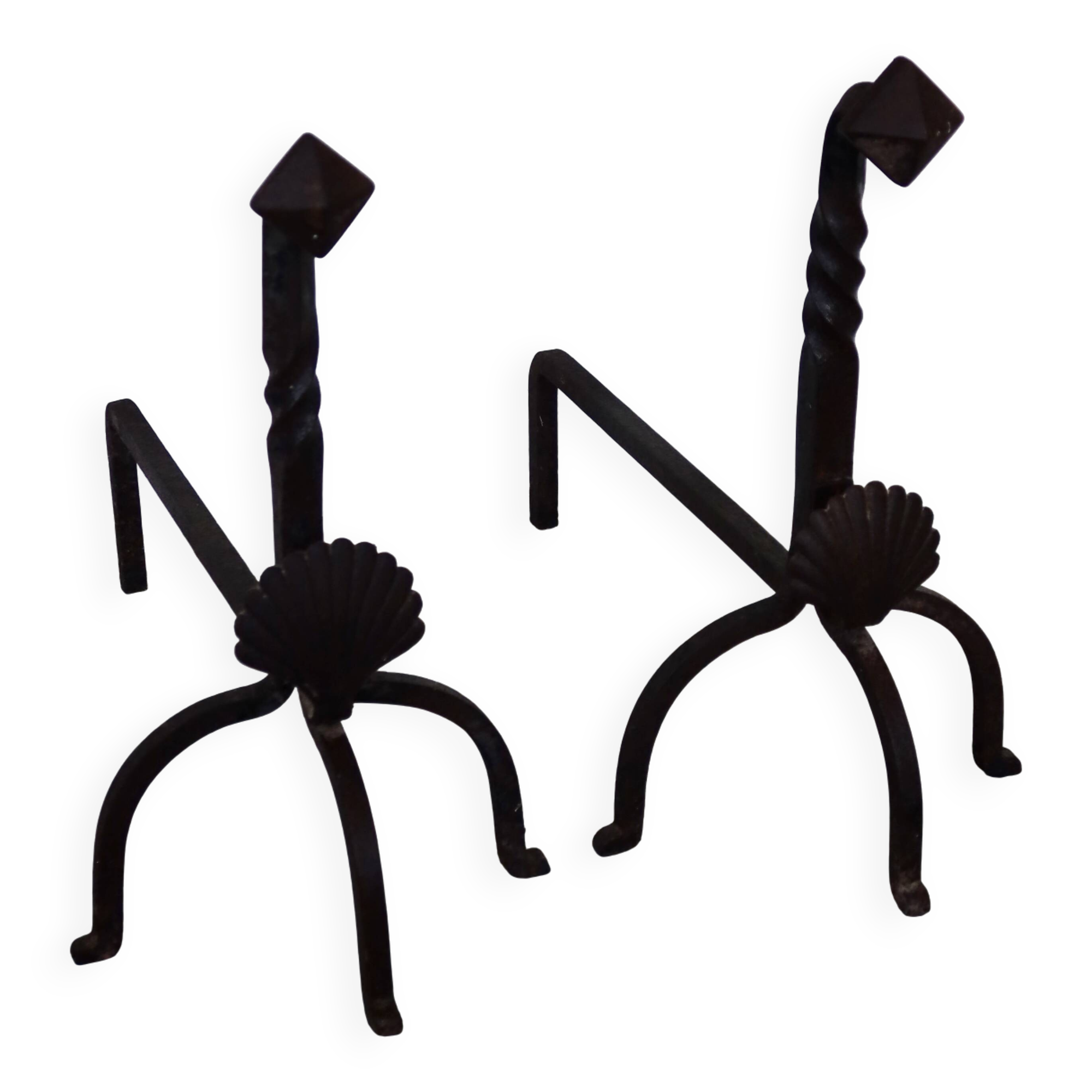 Vintage metal and cast iron fire dogs with shell motif.