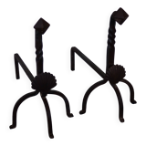 Vintage metal and cast iron fire dogs with shell motif.