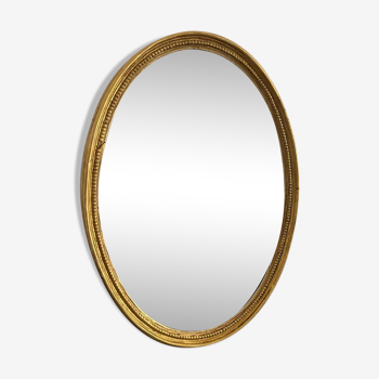 Old golden oval mirror