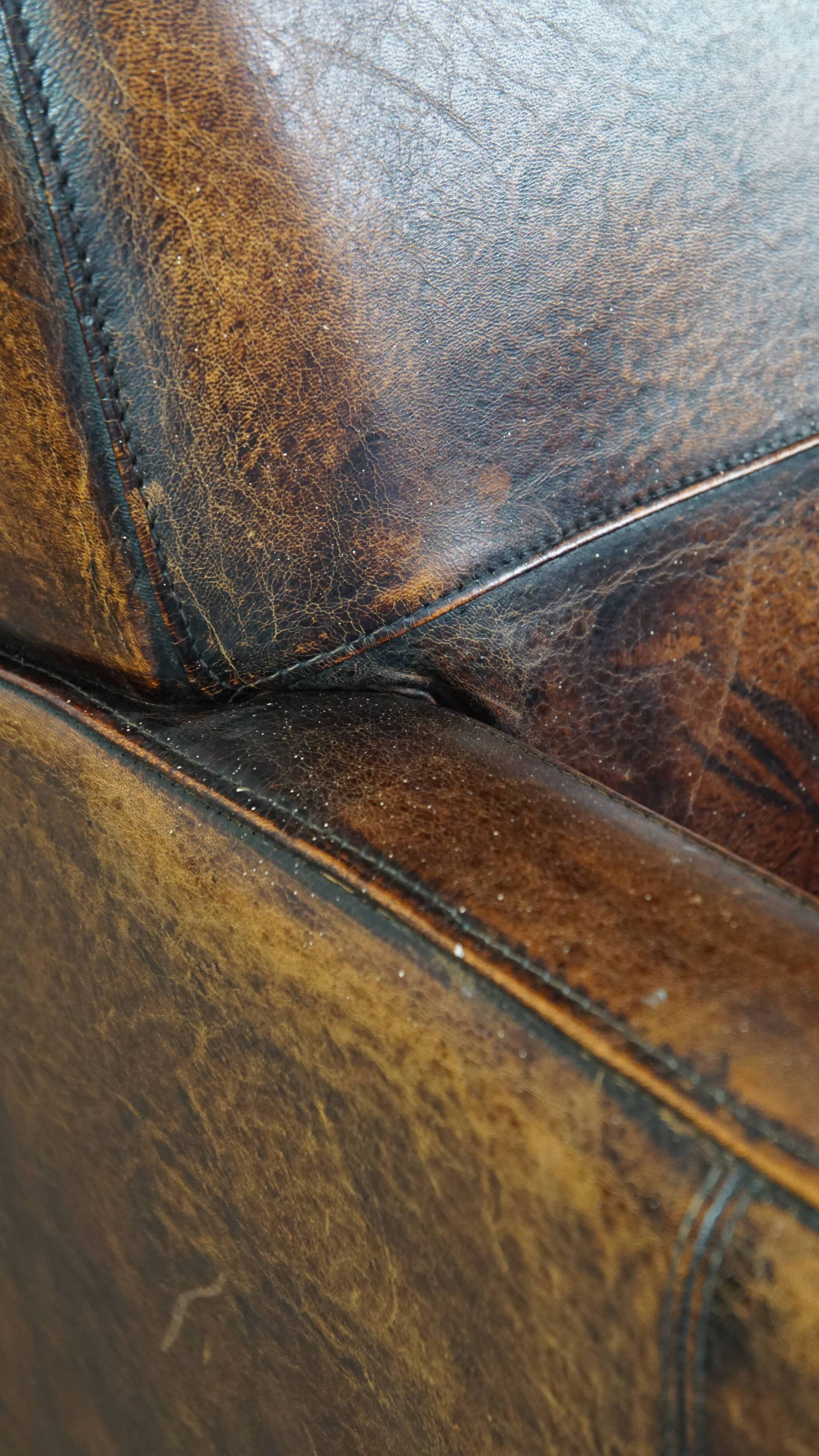 Dark brown design armchair made of sheepskin leather
