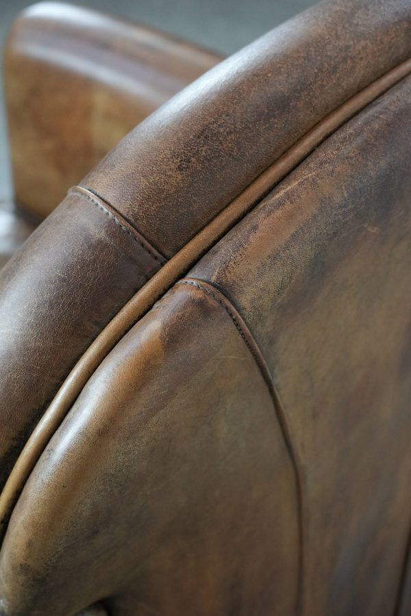 Beautiful vintage sheep leather armchair with a characterful appearance