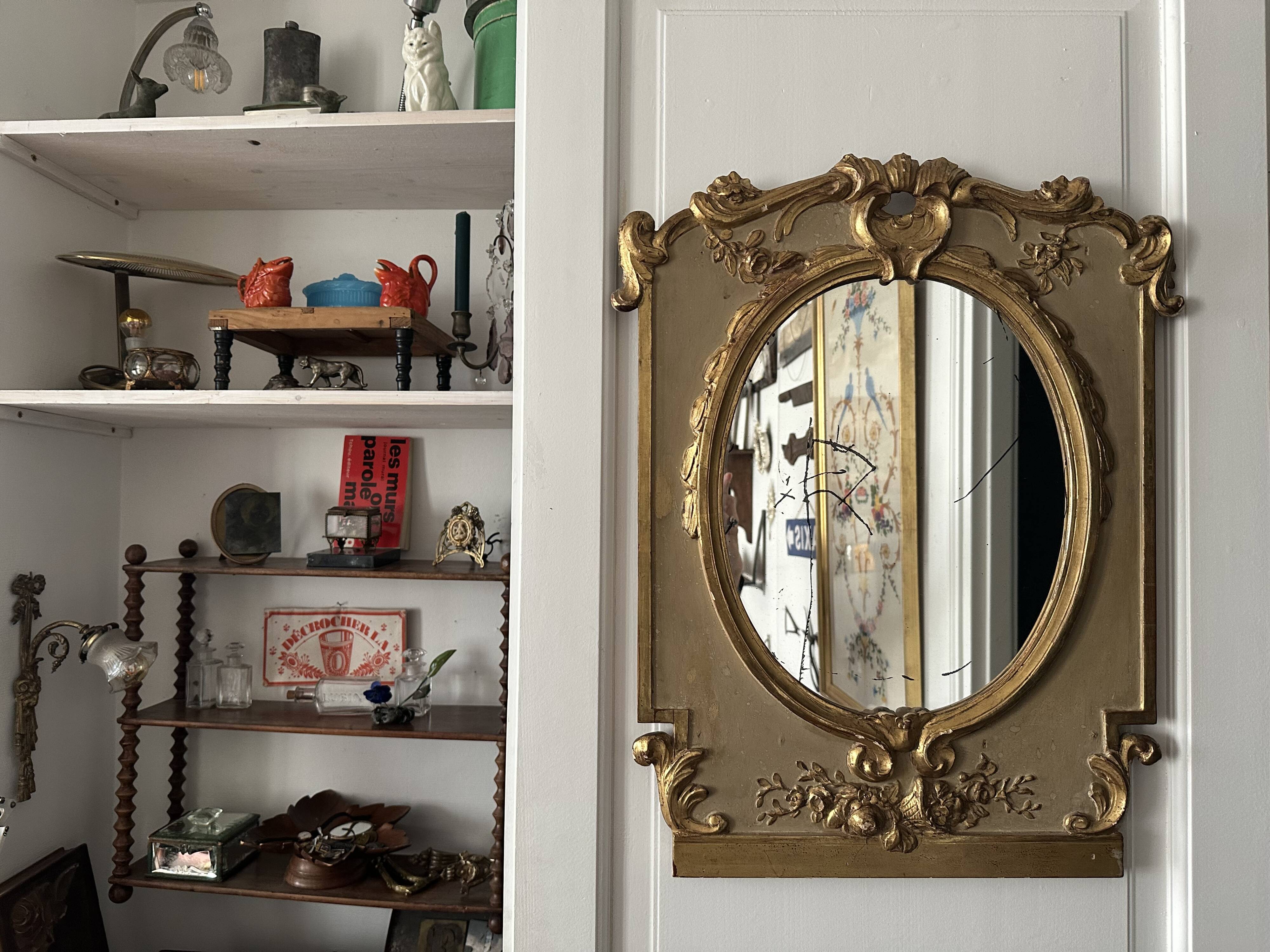 Napoleon III mirror in carved gilded wood, oval mercury glass.