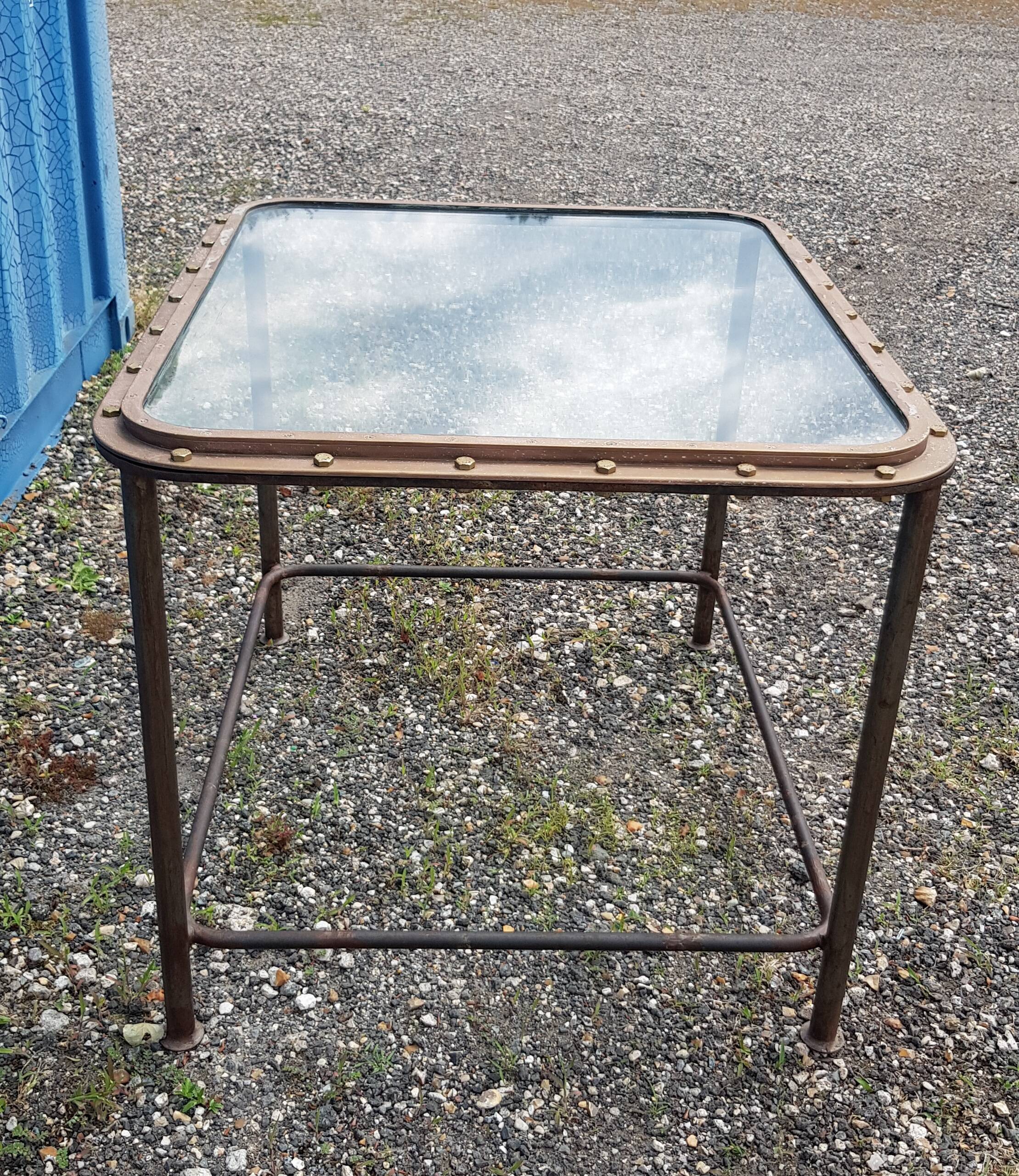 Table with an old ship porthole in brass and a metal base / 100 x 85 x 76 cm