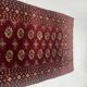 Antique wool rugs with designs on a red background, 20th century.