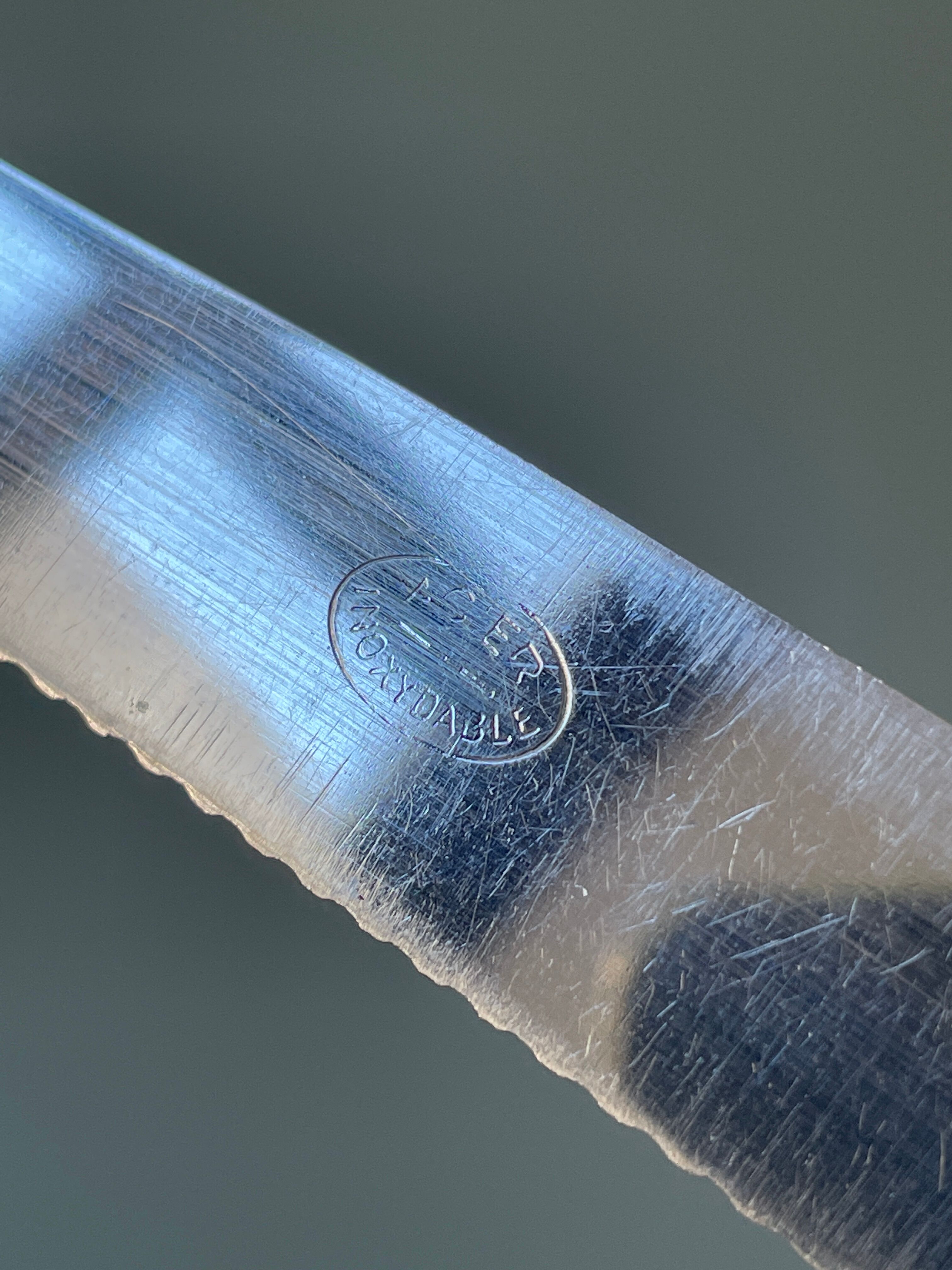 Series of 12 serrated vintage table knives