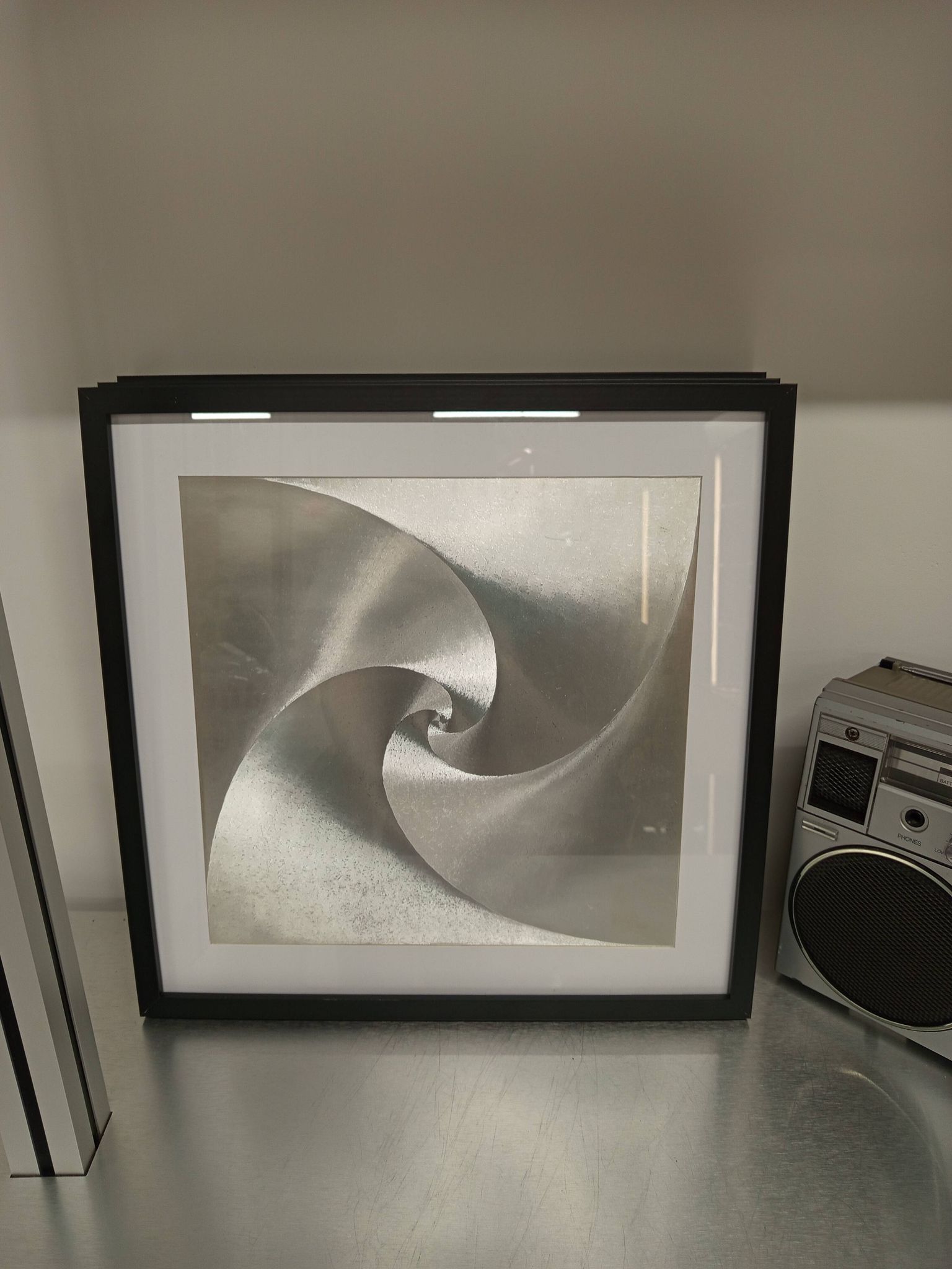 a Kinetic Op Art Aluchromy under glass frame.