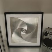 a Kinetic Op Art Aluchromy under glass frame.