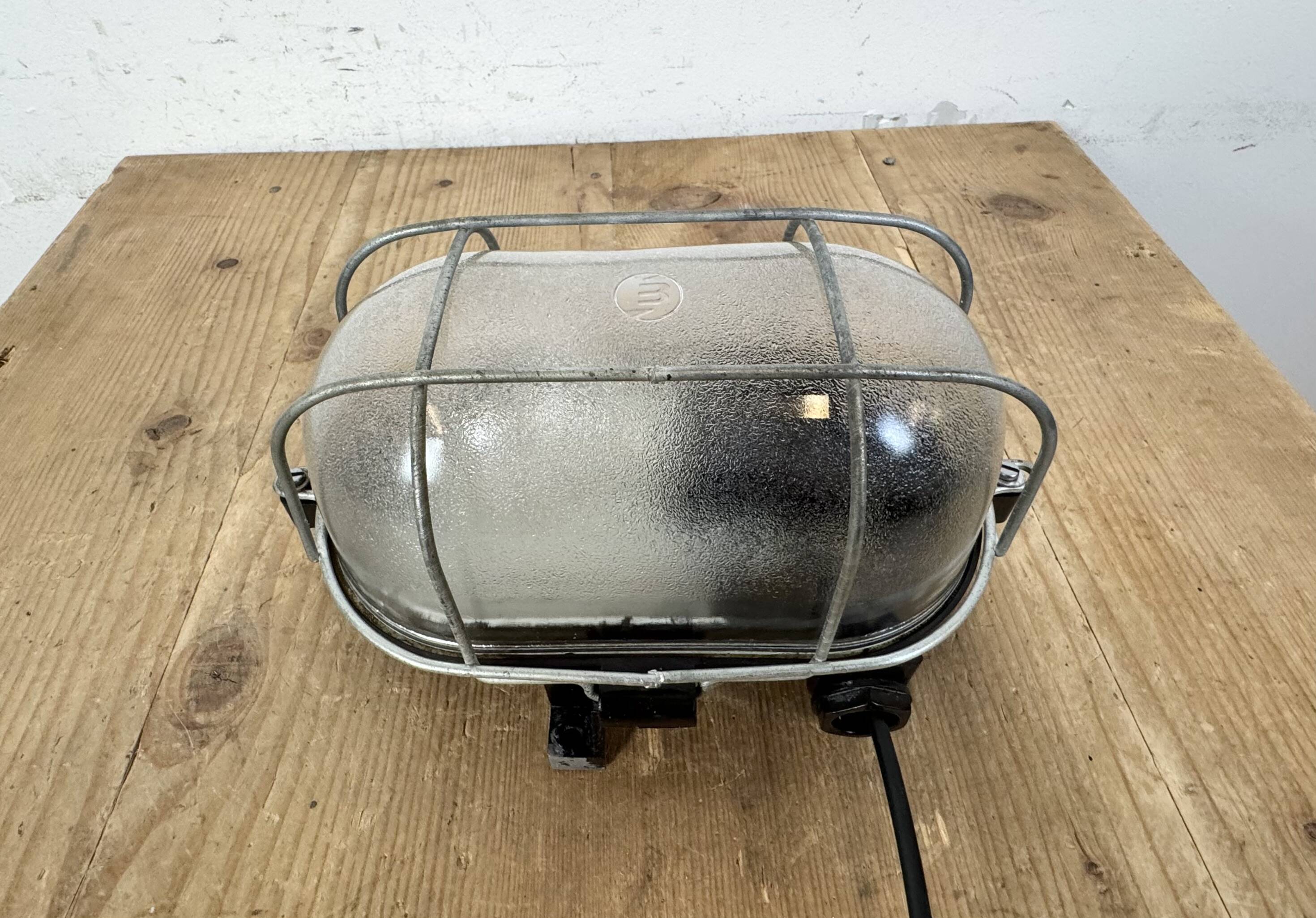 Industrial brown bakelite wall light with frosted glass, 1960s