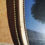 Old oval guilloche mirror, gilded and painted