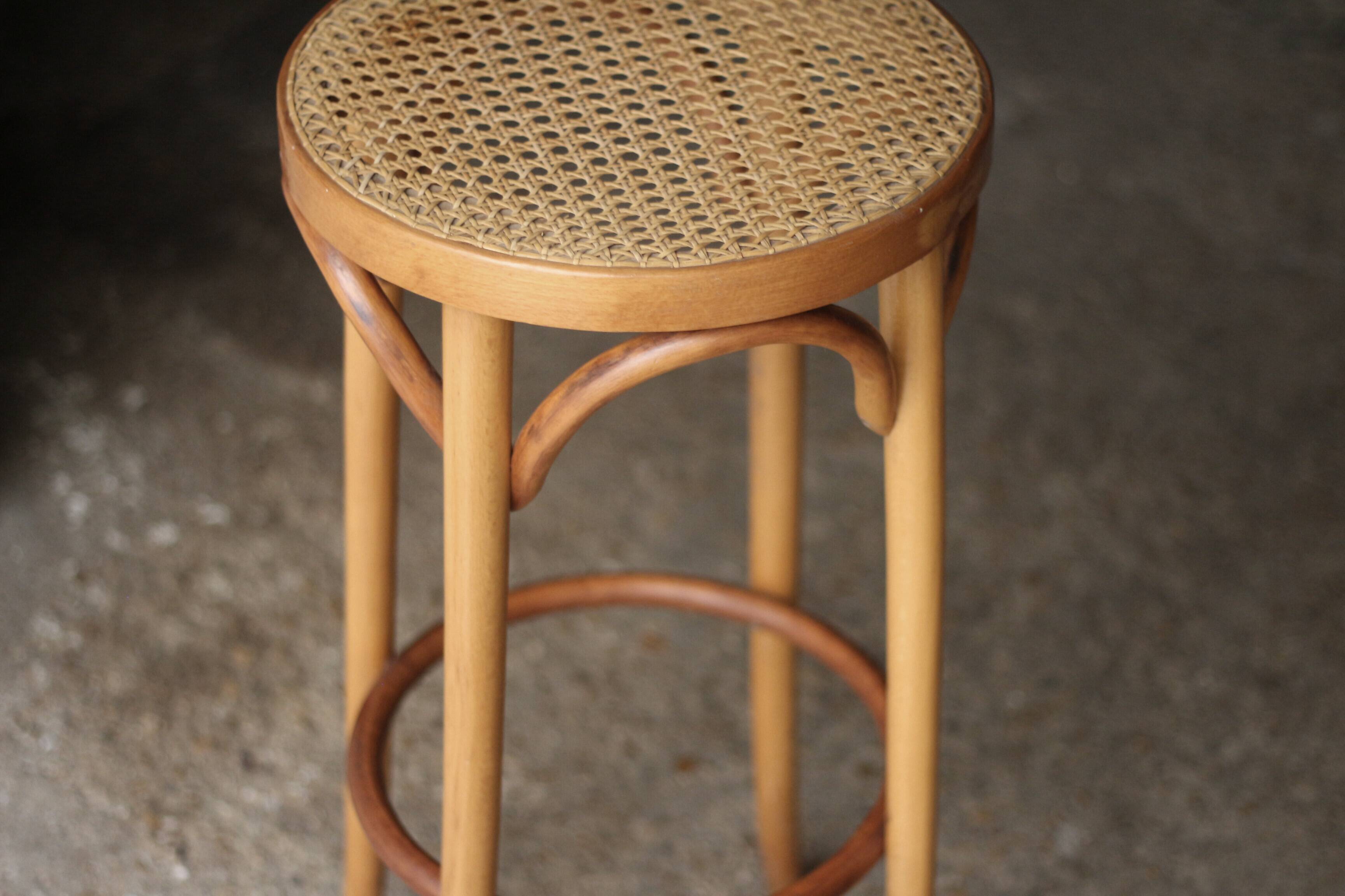 Beautiful caned stool in curved blond wood. 1940s/1950s
