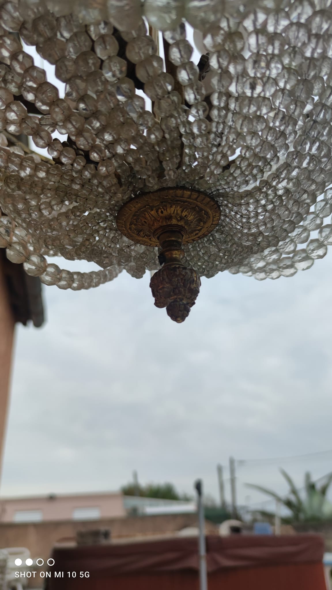 Antique bronze and crystal chandelier, formerly gas-powered, dating from the late 19th century.