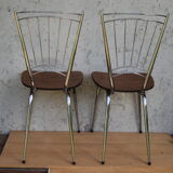 Pair of formica chairs with chrome metal backs in the shape of a lyre.