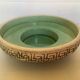 Green ceramic candle holder with a frieze