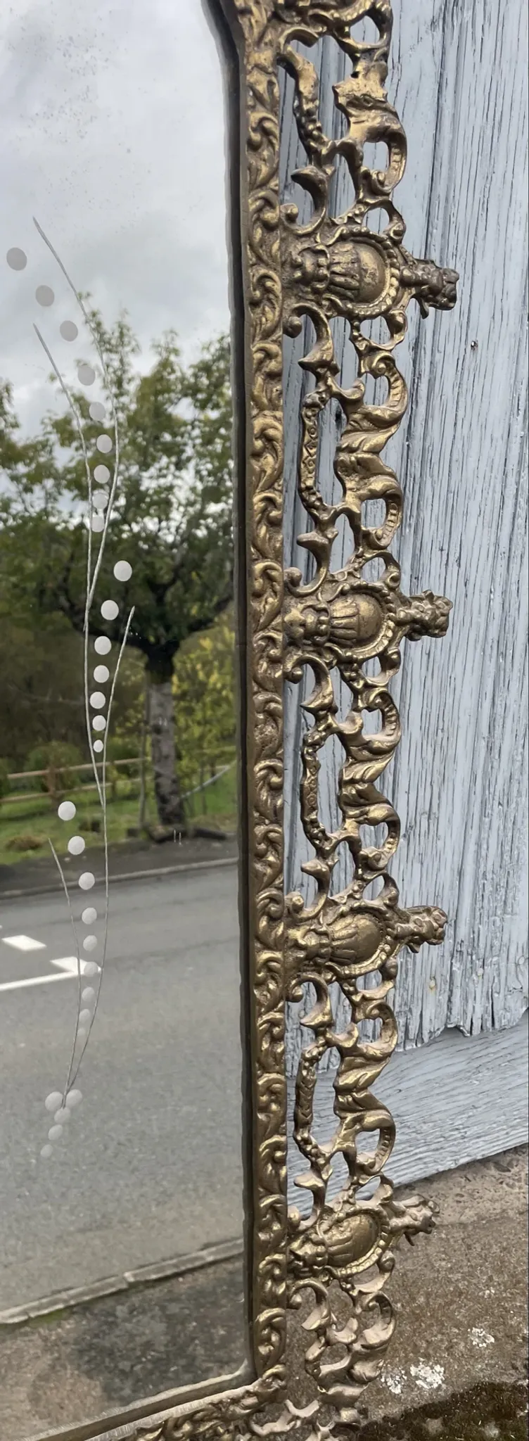 Vintage brass wall mirror adorned