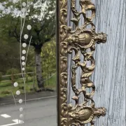 Vintage brass wall mirror adorned