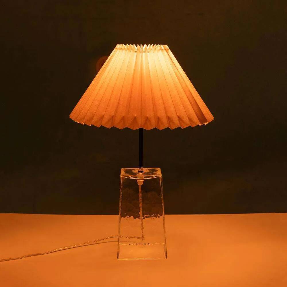 Minimalist glass table lamp from the 80s with a pleated shade.