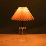 Minimalist glass table lamp from the 80s with a pleated shade.