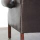 Chesterfield wing chair in dark brown leather with a luxurious appearance