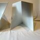 Pair of unmarked triangular white design stools