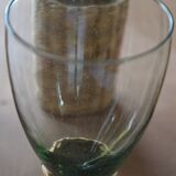 Four stemmed glasses surrounded by rattan.