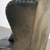 Antique black English cow leather wingback armchair from the 19th century