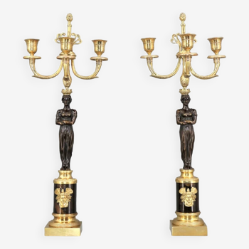 Pair of gilt and patinated bronze candlesticks with three Napoleon III candles