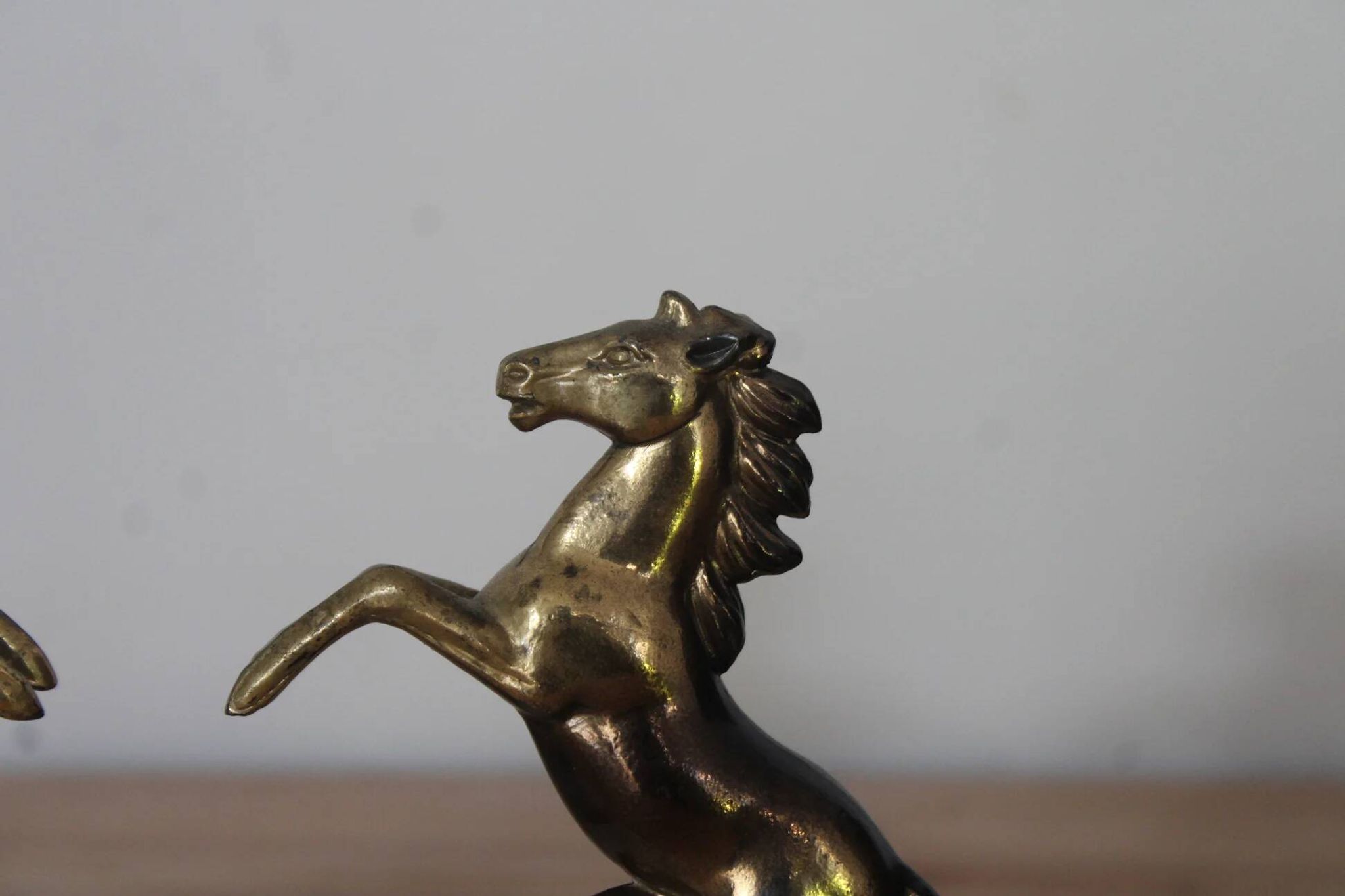 Pair of vintage bookends with rearing horses in gilded metal on marble bases.