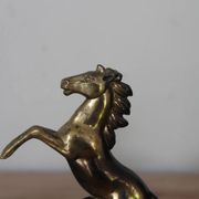 Pair of vintage bookends with rearing horses in gilded metal on marble bases.