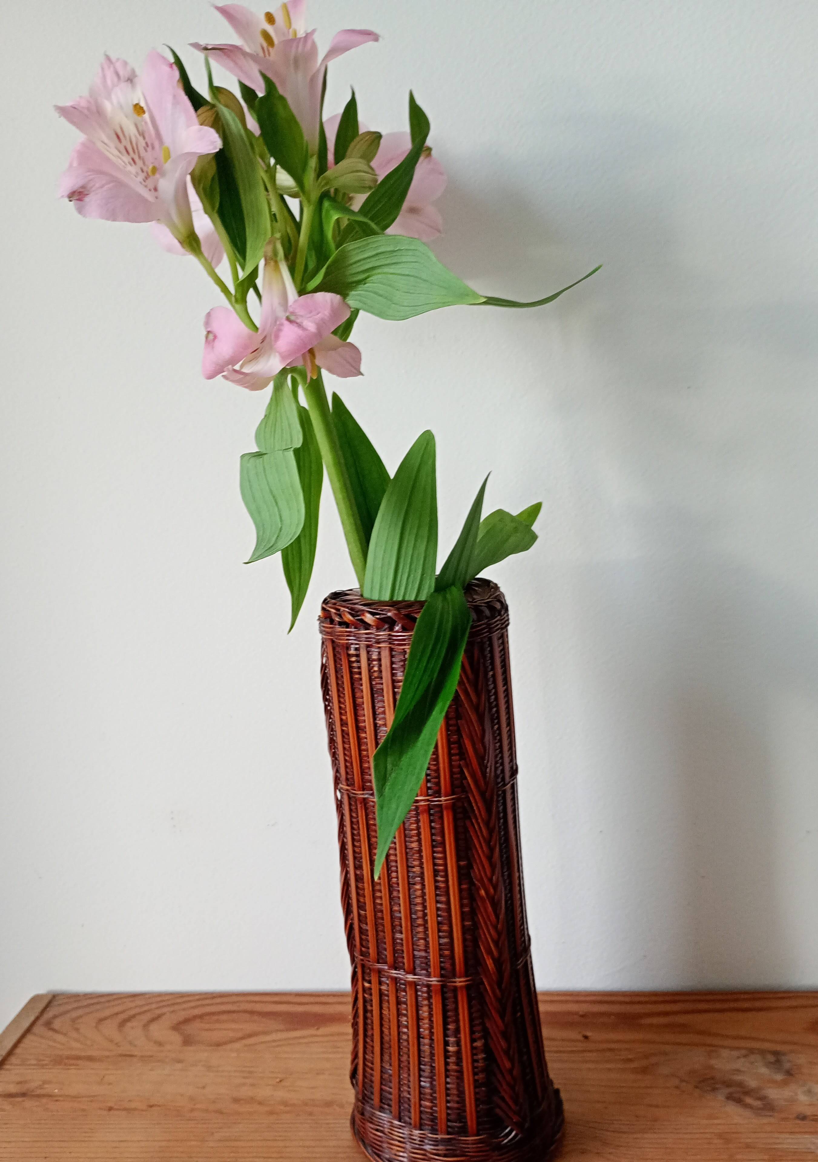 Japanese vase made of woven bamboo. Ikebana