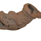 Cast iron gutter downspout in the shape of a dolphin