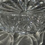 Circular glass ashtray with stylized petal patterns