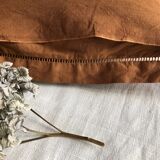 Old embroidered cushion tinted in speculoos