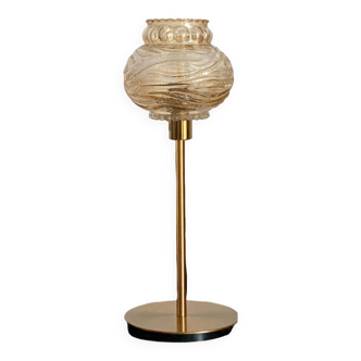 Table lamp with an antique textured globe and a golden base