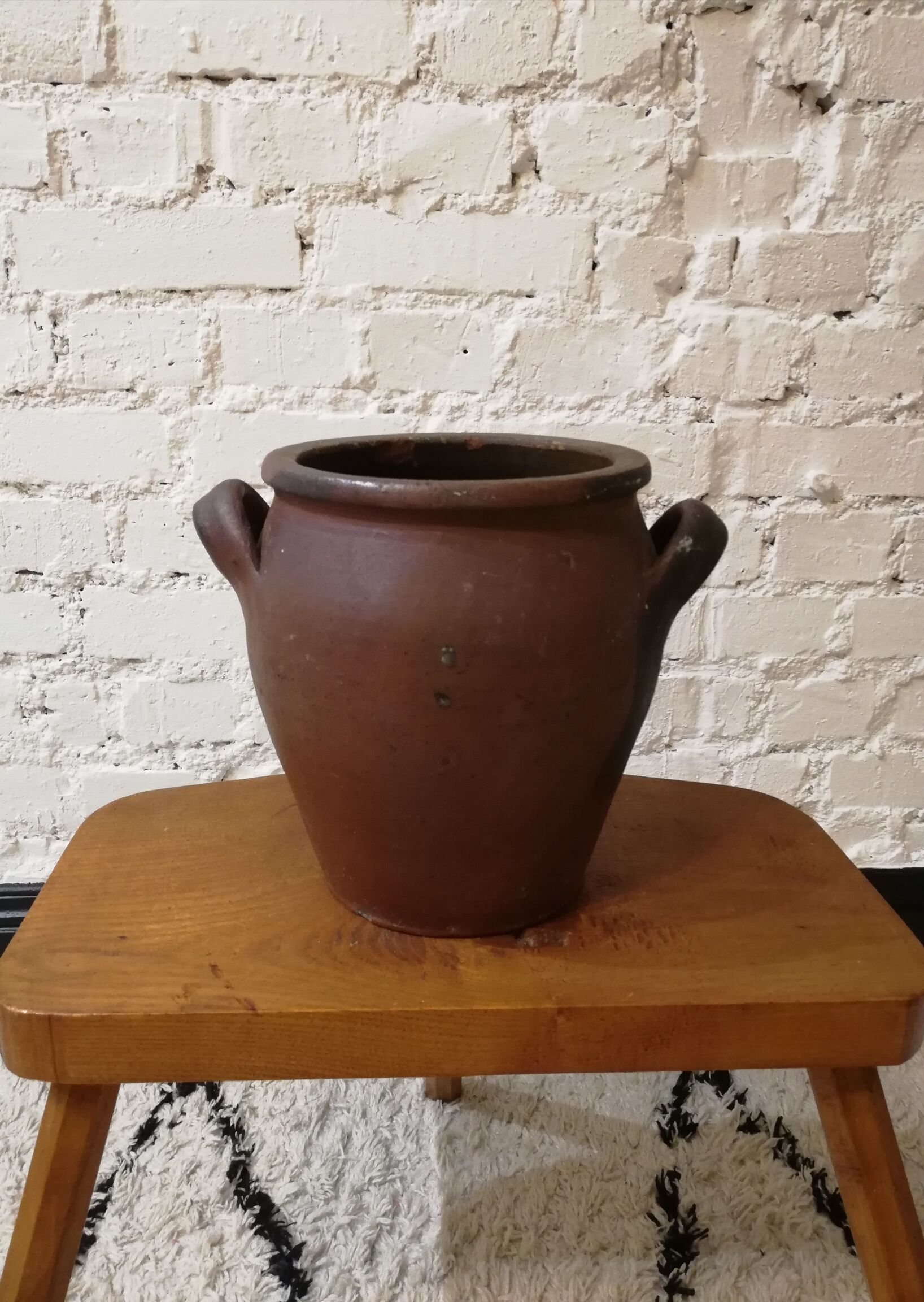 Old red and black terracotta grease pot