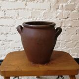 Old red and black terracotta grease pot