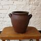 Old red and black terracotta grease pot