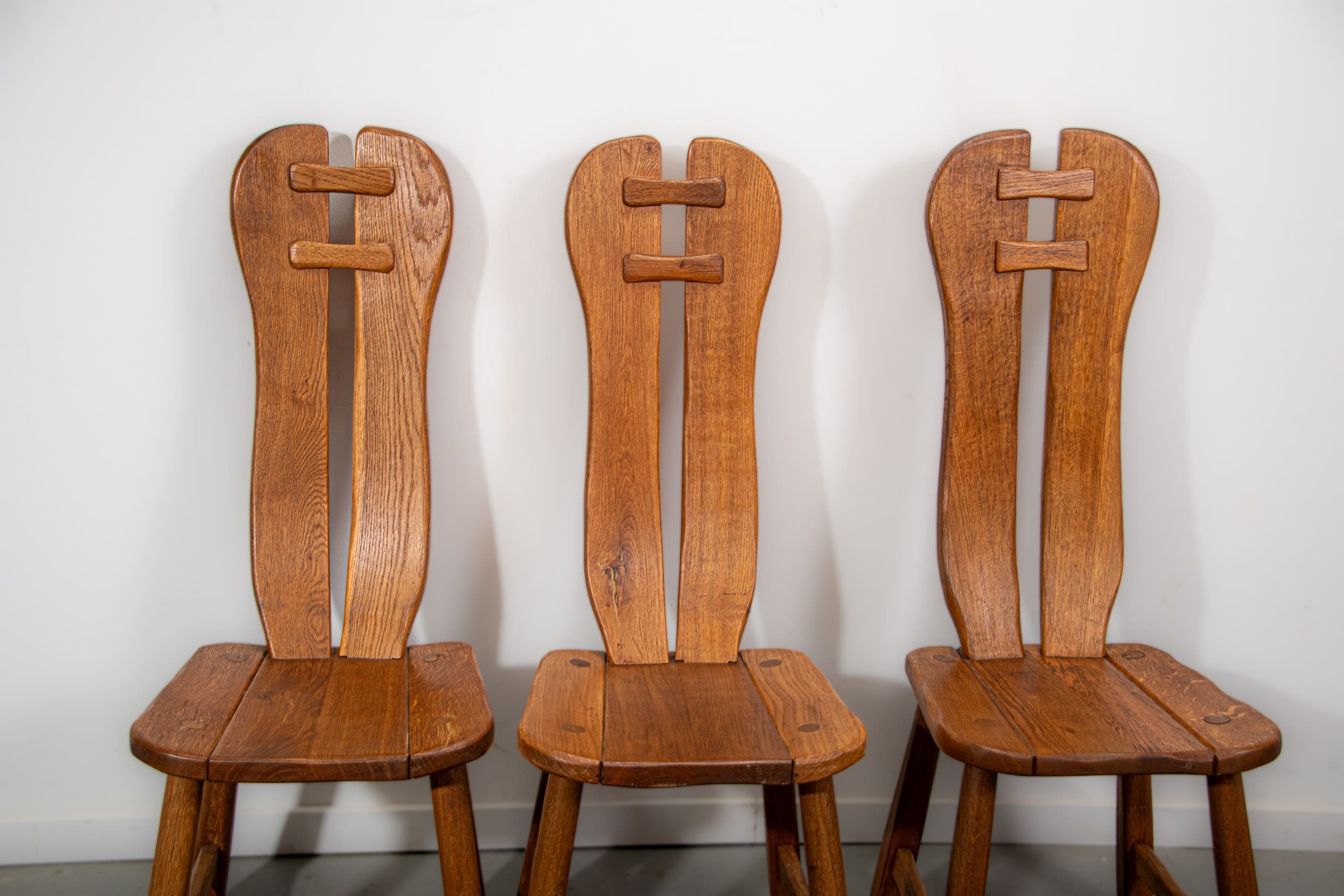 De Puydt brutalist dining chairs in solid oak. Circa 1970.