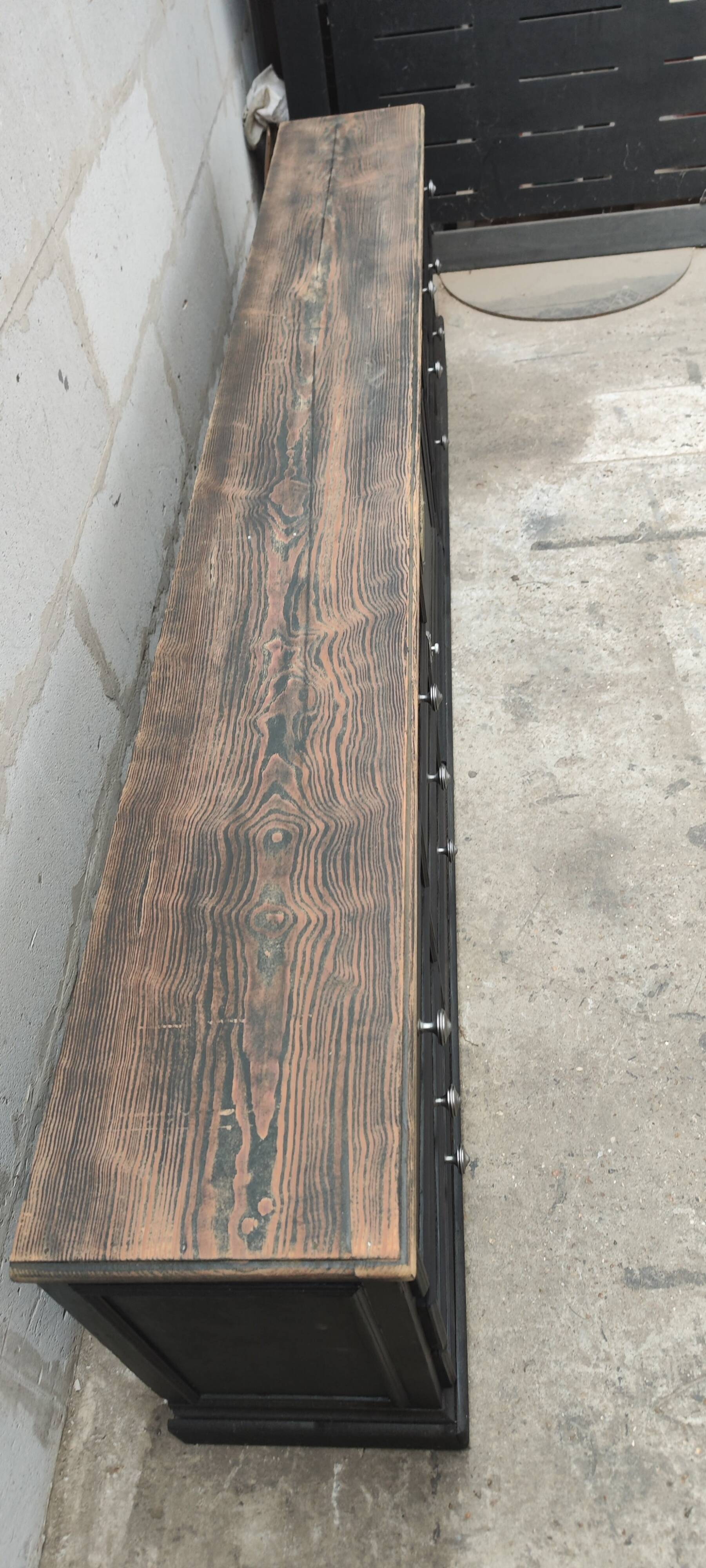 Low TV cabinet with black patina, twelve drawers and one door