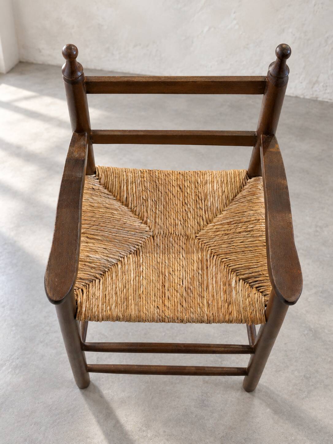 High chair made of straw and wood