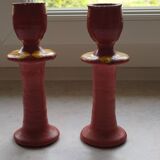 A pair of glazed earthenware candlesticks.