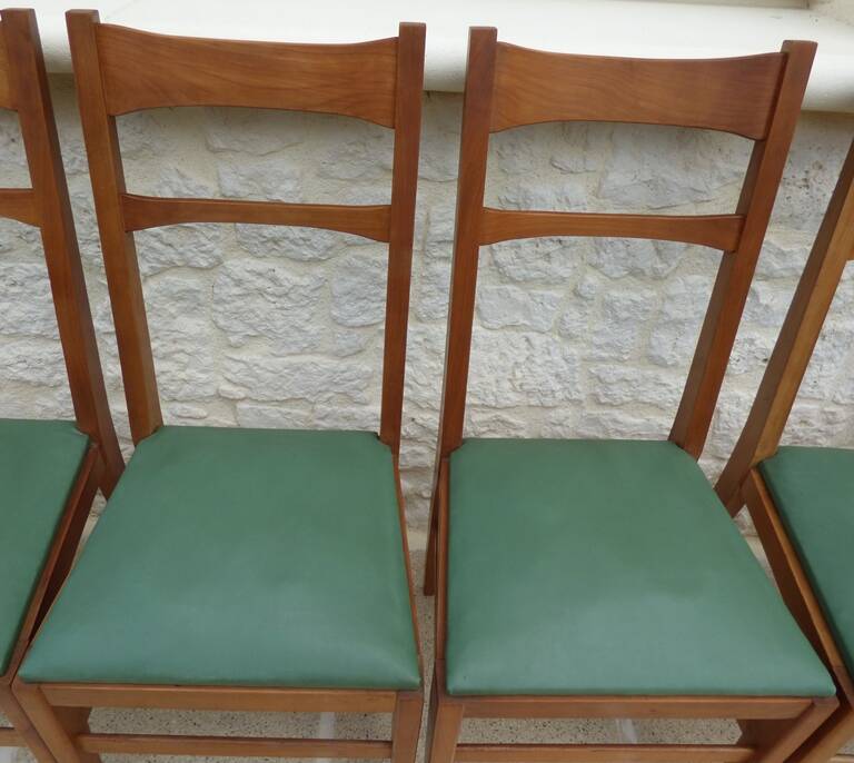 6 modern chairs with banded backs and green faux leather seats