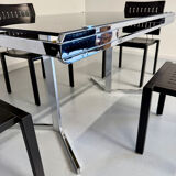 Smoked glass dining table with chrome legs, 1970s design by Roche Bobois.