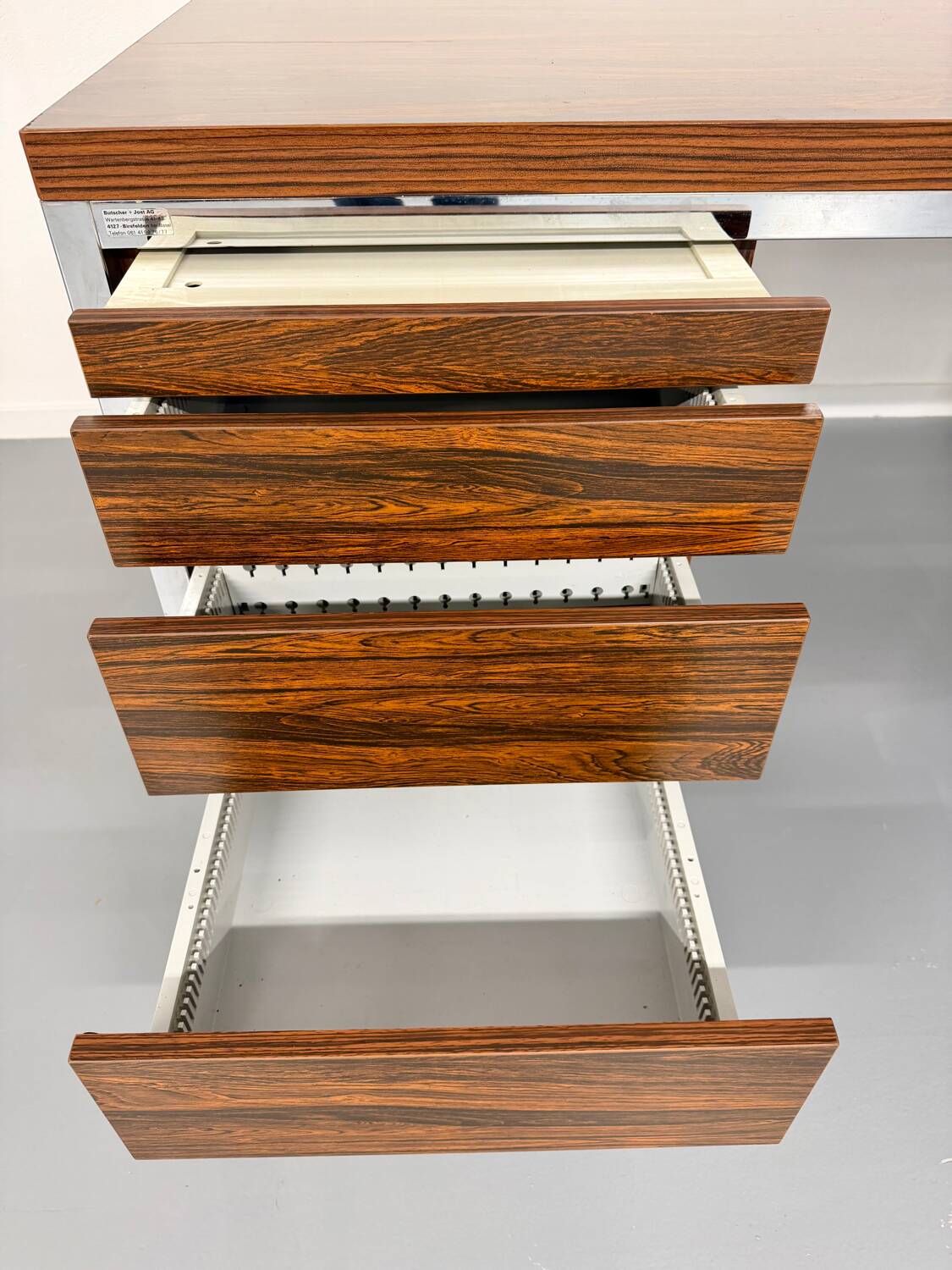Vintage desk with rosewood veneer and chrome metal design from the 1970s.