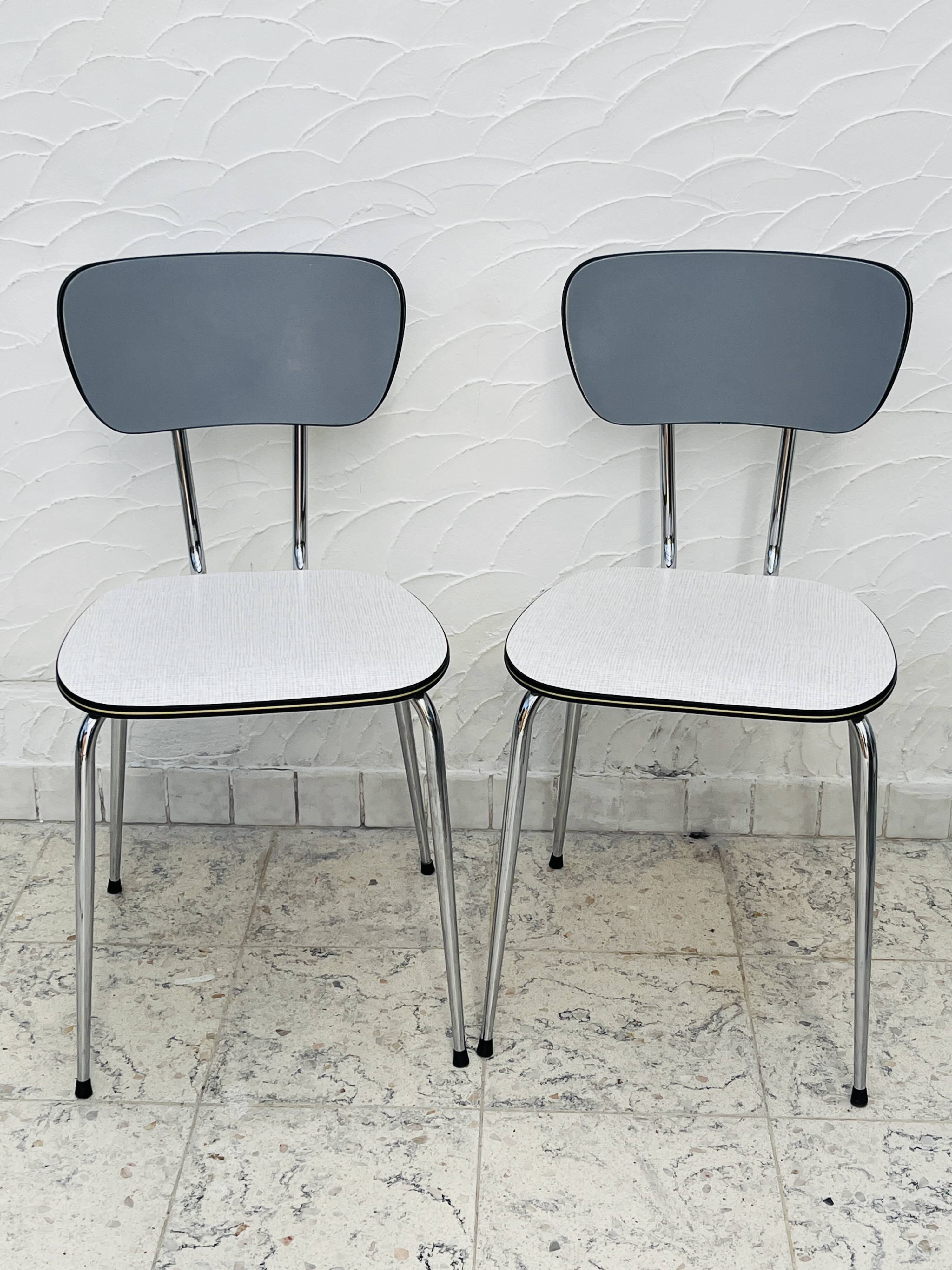 Set of two vintage grey Formica and chrome chairs.