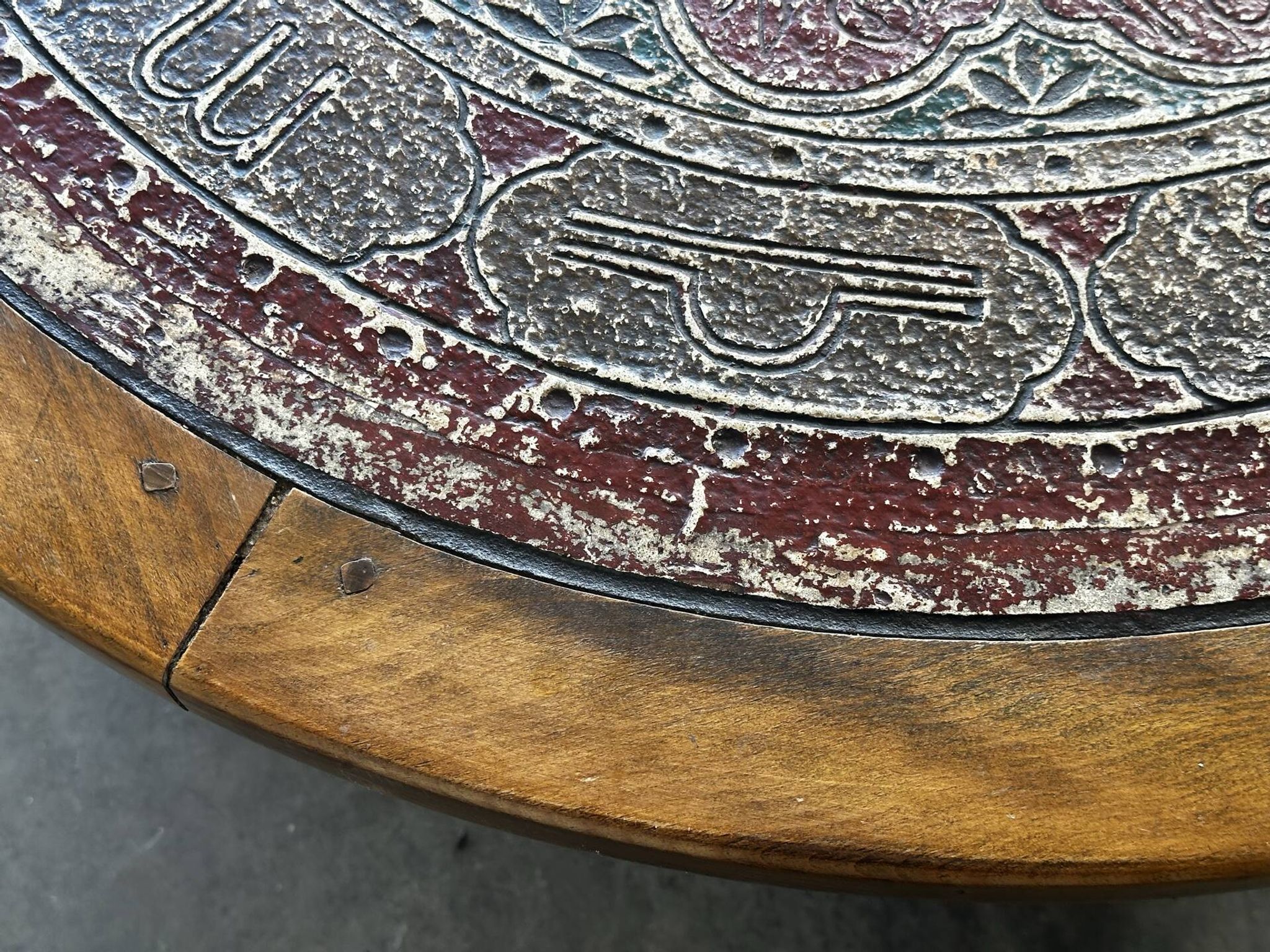 Vintage wooden turned coffee table with leather and astrological decoration.